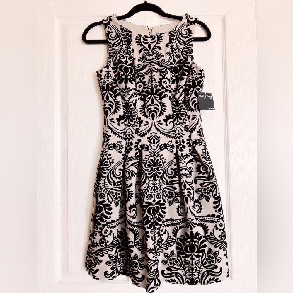 This dress is a stunner! Embossed black velvet baroque adorns entire dress.